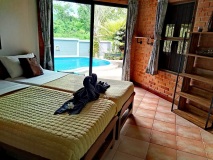 Relax-in-this-room-with-a-double-beds-enjoying-picturesque-views-of-the-terrace-and-pool