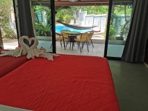 Spacious-room-with-double-beds-overlooking-the-terrace-and-pool